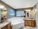 Bathroom with tub, double vanity sinks, and tile floors at 104 Bentley Oaks Blvd, Auburndale, FL 33823