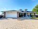 Charming single Gathering home boasts stone accents, dormer windows and a brick paved driveway at 104 Bentley Oaks Blvd, Auburndale, FL 33823