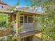 A cozy, covered balcony featuring white railings and a view framed by lush foliage, enhancing the outdoor living experience at 10852 Spider Lily Dr # S, Orlando, FL 32832