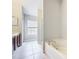 An open bathroom layout featuring a corner tub and separate shower, with neutral tile flooring and updated fixtures at 10852 Spider Lily Dr # S, Orlando, FL 32832