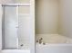 Bright bathroom with a glass-enclosed shower, tiled walls, and a separate soaking tub for a spa-like experience at 10852 Spider Lily Dr # S, Orlando, FL 32832