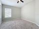 A cozy bedroom with neutral walls, plush carpet, and a large window for ample light at 10852 Spider Lily Dr # S, Orlando, FL 32832