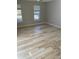 Bright and airy bedroom with wood floors, neutral paint, and natural light from the windows at 10852 Spider Lily Dr # S, Orlando, FL 32832