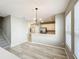 Inviting dining area with modern lighting, wood floors, and easy access to kitchen with white cabinets at 10852 Spider Lily Dr # S, Orlando, FL 32832