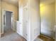 Hallway with neutral colors, plush carpet, white doors, and stairwell to another level at 10852 Spider Lily Dr # S, Orlando, FL 32832