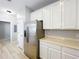 Kitchen features stainless steel appliances, white cabinets, and stone countertops at 10852 Spider Lily Dr # S, Orlando, FL 32832