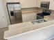 Kitchen featuring stainless steel appliances, white cabinets, marble countertops, breakfast bar and wood flooring at 10852 Spider Lily Dr # S, Orlando, FL 32832