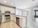 Modern kitchen with stainless steel appliances and white cabinets and countertops at 10852 Spider Lily Dr # S, Orlando, FL 32832