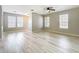 Spacious open-concept living room with wood-look floors and natural light at 10852 Spider Lily Dr # S, Orlando, FL 32832