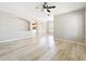 Bright, open living room with hardwood floors, neutral paint, elegant archways, and a modern ceiling fan at 10852 Spider Lily Dr # S, Orlando, FL 32832