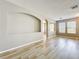 Bright living room with wood-look flooring and archway to the kitchen at 10852 Spider Lily Dr # S, Orlando, FL 32832