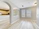 Bright living room with wood-look flooring and archway to the kitchen at 10852 Spider Lily Dr # S, Orlando, FL 32832