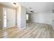 Inviting living room featuring wood-look floors and natural light from the entryway at 10852 Spider Lily Dr # S, Orlando, FL 32832