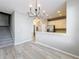 Open concept living area with modern lighting, hardwood floors, and a partial view of the kitchen at 10852 Spider Lily Dr # S, Orlando, FL 32832