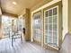 Covered outdoor patio with chairs and sliding glass doors at 10852 Spider Lily Dr # S, Orlando, FL 32832