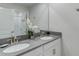 Elegant bathroom featuring double sinks, gray quartz countertops, modern fixtures, and a large mirror at 1188 Challenge Dr, Davenport, FL 33896
