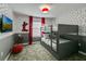 Fun bedroom with bunk beds, polka dot wallpaper, a Mickey Mouse lamp, and a flat-screen TV at 1188 Challenge Dr, Davenport, FL 33896