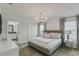 Bedroom featuring a chandelier, en-suite bathroom, and neutral color palette at 1188 Challenge Dr, Davenport, FL 33896