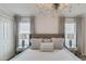 Bedroom with a chandelier, tufted headboard, side tables, and plush bedding at 1188 Challenge Dr, Davenport, FL 33896