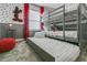 Gray bunk beds with a pull-out trundle, polka-dot wall design, and Mickey Mouse wall decor at 1188 Challenge Dr, Davenport, FL 33896