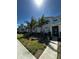Inviting townhome showcasing modern architecture, well-kept lawn, and landscaped walkway at 1188 Challenge Dr, Davenport, FL 33896