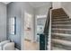 Hallway with stairs, elegant wall decor, leading to bedrooms and bathrooms at 1188 Challenge Dr, Davenport, FL 33896