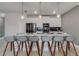 Modern kitchen with stainless steel appliances, white cabinetry, and a large island with seating for six at 1188 Challenge Dr, Davenport, FL 33896