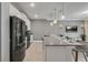 Spacious kitchen with a gray countertop island, stainless steel appliances, and an open layout to the living area at 1188 Challenge Dr, Davenport, FL 33896