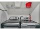 Well-equipped laundry room with modern washer and dryer units, shelving, and ample storage space at 1188 Challenge Dr, Davenport, FL 33896