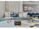 Comfortable living room featuring a plush sofa, decorative pillows, and a view into the dining area at 1188 Challenge Dr, Davenport, FL 33896