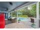 Covered back patio with brick flooring features outdoor wicker furniture, ceiling fans, and a clear view of the pool at 1311 Olympia Park Cir, Ocoee, FL 34761