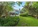 Beautiful backyard with a patio, seating, in-ground pool and lush landscaping at 1311 Olympia Park Cir, Ocoee, FL 34761
