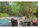 Backyard features a pool and hot tub next to a gas fire pit surrounded by outdoor furniture, perfect for relaxing at 1311 Olympia Park Cir, Ocoee, FL 34761