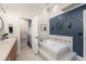 Well-lit bathroom boasts patterned wallpaper, a soaking tub with tile surround, and a step-in shower at 1311 Olympia Park Cir, Ocoee, FL 34761