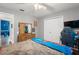 Comfortable bedroom has closet, mirror, and a soft bedspread next to the gaming chair, and desk on the right at 1311 Olympia Park Cir, Ocoee, FL 34761