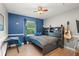 This bedroom features a grey bookcase headboard, blue walls, and hardwood floors at 1311 Olympia Park Cir, Ocoee, FL 34761