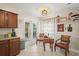Cozy breakfast nook with warm lighting, small table with two chairs, tile flooring and a backyard view at 1311 Olympia Park Cir, Ocoee, FL 34761