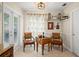 Cozy breakfast nook with warm lighting, small table with two chairs, tile flooring and an exterior door at 1311 Olympia Park Cir, Ocoee, FL 34761