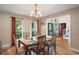 Dining room with stylish table setting, chandelier, hardwood floors, and natural light at 1311 Olympia Park Cir, Ocoee, FL 34761