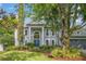 Attractive two-story home featuring a symmetrical facade, classic columns, and a well-maintained lawn at 1311 Olympia Park Cir, Ocoee, FL 34761