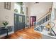 Elegant foyer with hardwood floors, staircase, decorative lighting, and stylish entryway decor at 1311 Olympia Park Cir, Ocoee, FL 34761