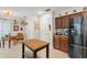 Bright kitchen featuring stainless steel refrigerator, granite countertops, and a functional kitchen island at 1311 Olympia Park Cir, Ocoee, FL 34761