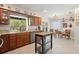 Bright kitchen features stone countertops, stainless steel appliances, wood cabinets and island at 1311 Olympia Park Cir, Ocoee, FL 34761