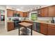 Kitchen showcasing granite countertops, stainless steel appliances, and a functional center kitchen island at 1311 Olympia Park Cir, Ocoee, FL 34761