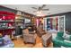 Unique living room featuring hardwood floors, eye-catching built-in shelves, and comfortable seating at 1311 Olympia Park Cir, Ocoee, FL 34761