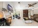 Spacious living room features vaulted ceilings, fireplace, built-in shelving, tile floors, and comfortable seating at 1311 Olympia Park Cir, Ocoee, FL 34761