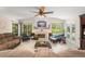 Bright living room with fireplace, vaulted ceilings, lots of windows, and comfortable seating at 1311 Olympia Park Cir, Ocoee, FL 34761