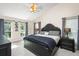 Spacious main bedroom features large windows with a ceiling fan and a dark wood bed set at 1311 Olympia Park Cir, Ocoee, FL 34761