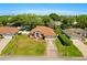 An aerial view showcases this lovely property, its green lawn, and surrounding neighborhood at 1330 Broken Pine Rd, Deltona, FL 32725
