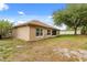 Spacious backyard with grass, a tree, and the exterior of the home at 1330 Broken Pine Rd, Deltona, FL 32725